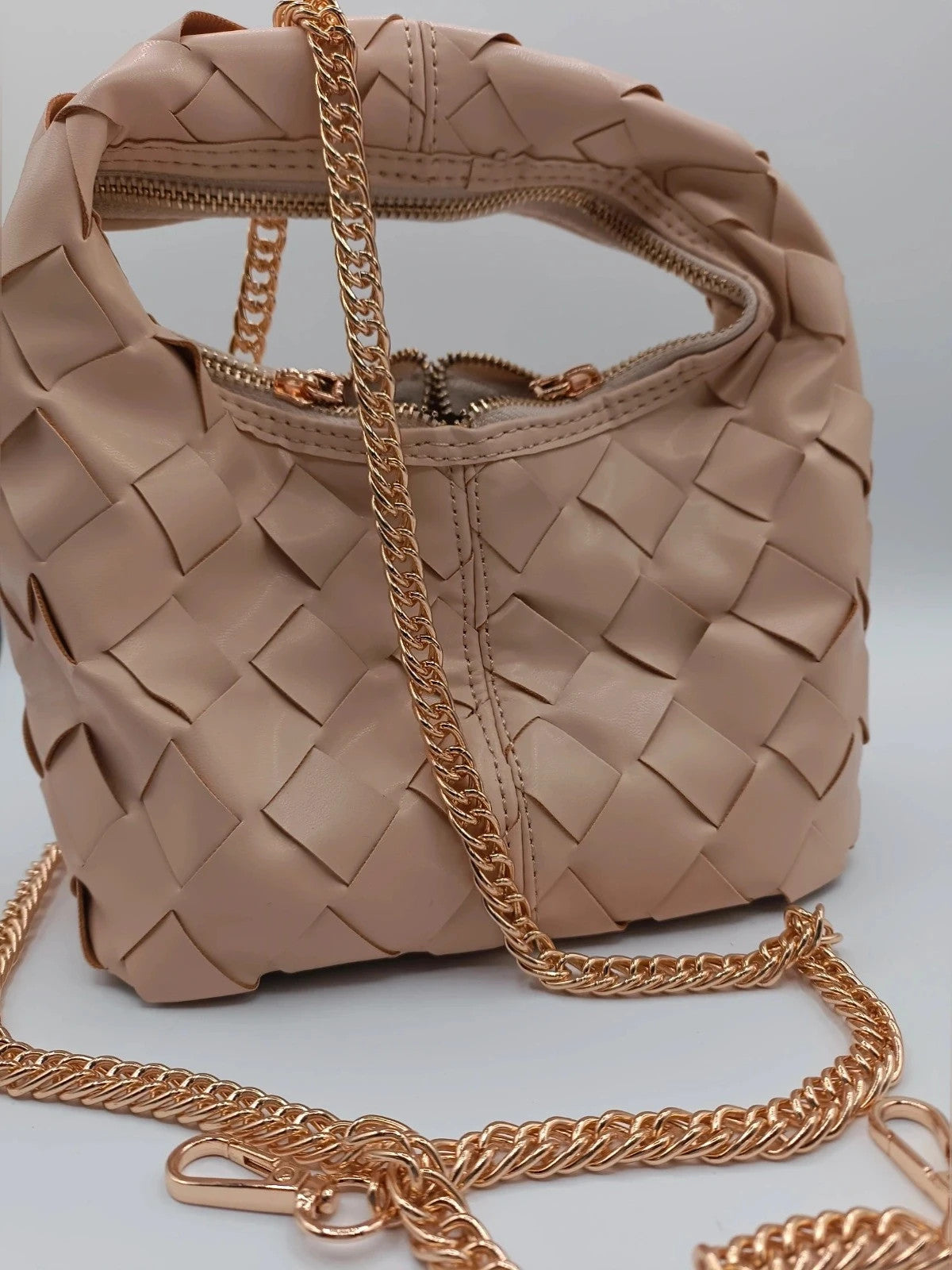 Pelle beige handbag with gold strap, made of PU leather, stylish design.