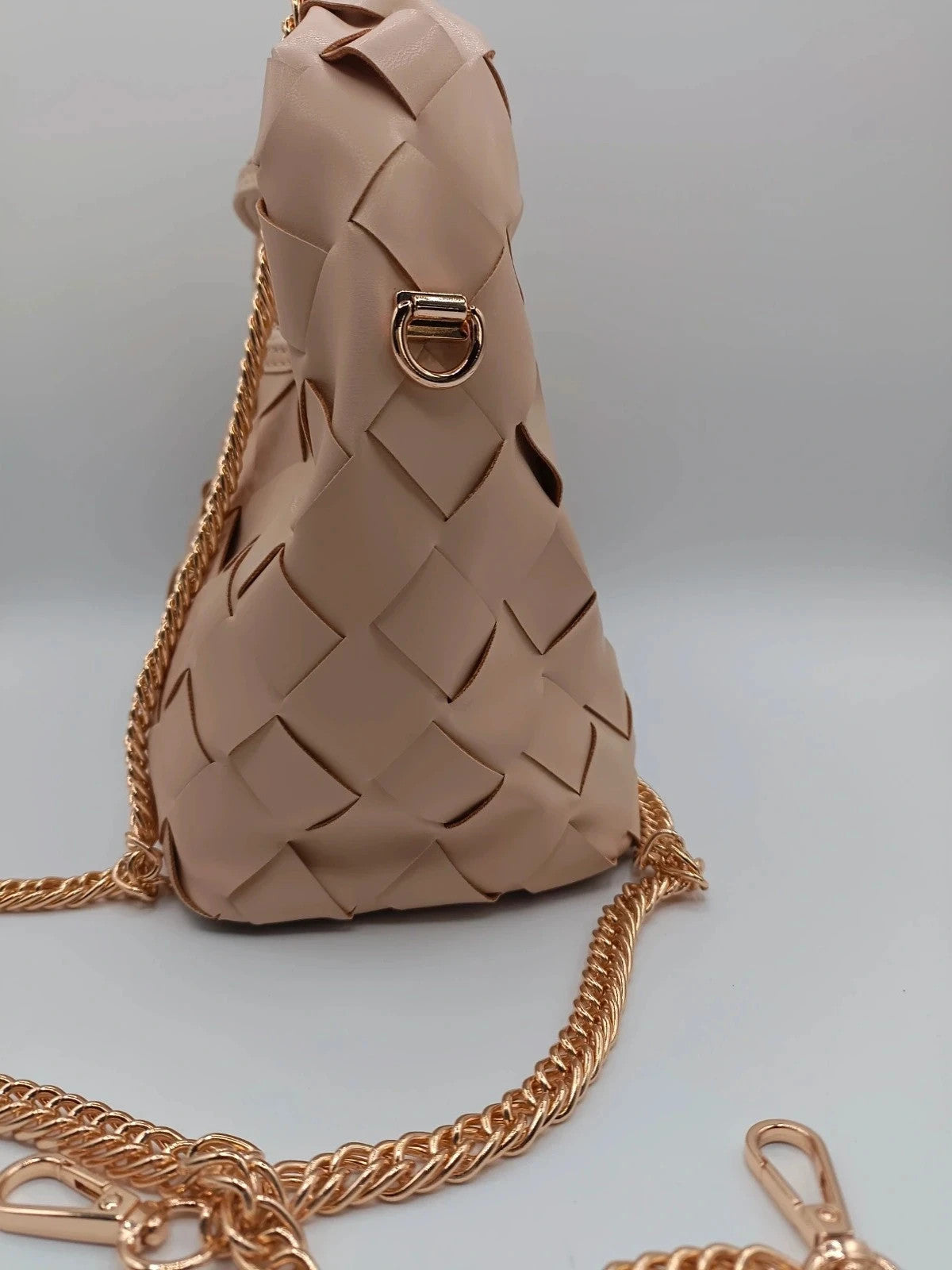 Pelle beige handbag with gold strap, made of PU leather, stylish design.