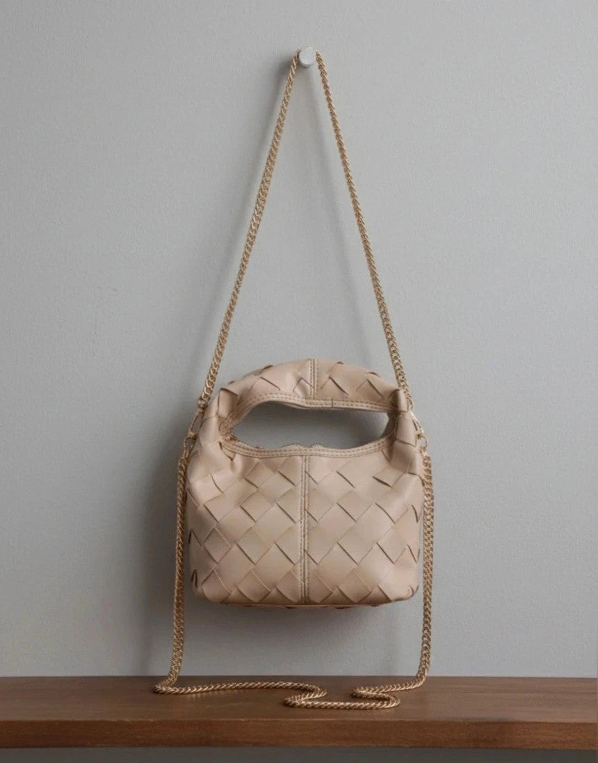 Pelle beige handbag with gold strap, made of PU leather, stylish design.