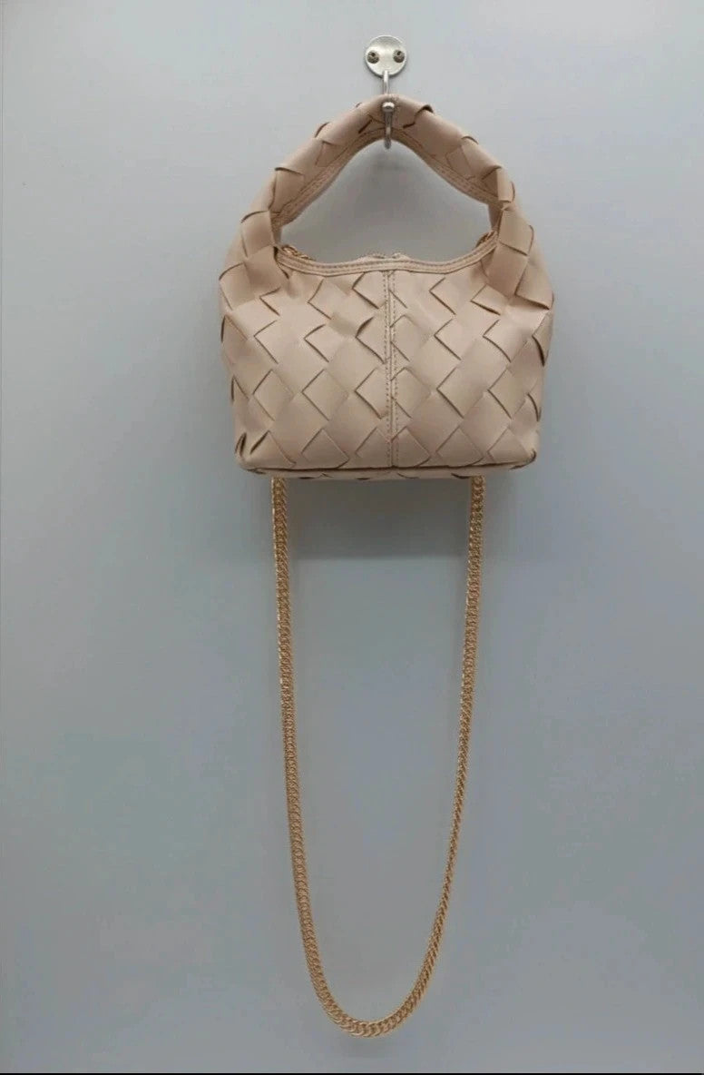 Pelle beige handbag with gold strap, made of PU leather, stylish design.