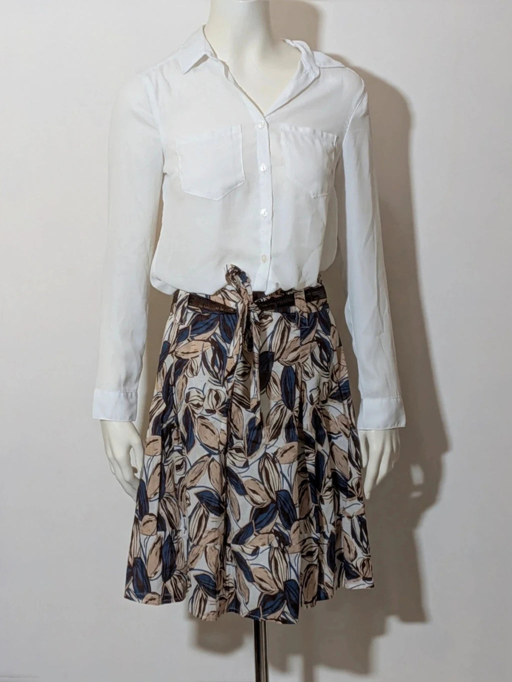 Jennifer beige skirt suit with floral pattern, white button-up shirt, lightweight polyester fabric.