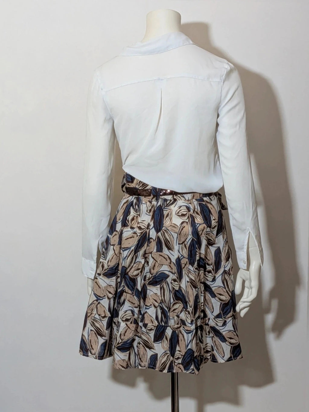 Jennifer beige skirt suit with floral pattern, white button-up shirt, lightweight polyester fabric.