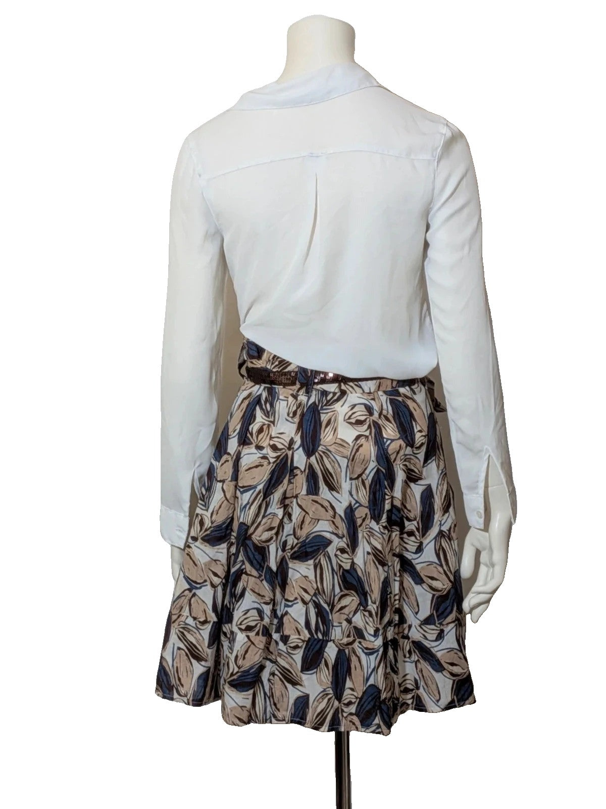 Jennifer beige skirt suit with floral pattern, white button-up shirt, lightweight polyester fabric.