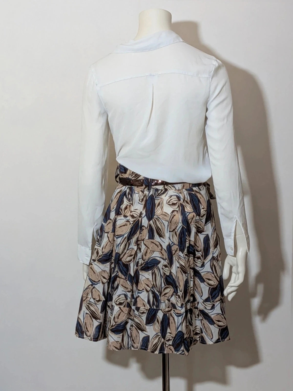 Jennifer beige skirt suit with floral pattern, white button-up shirt, lightweight polyester fabric.