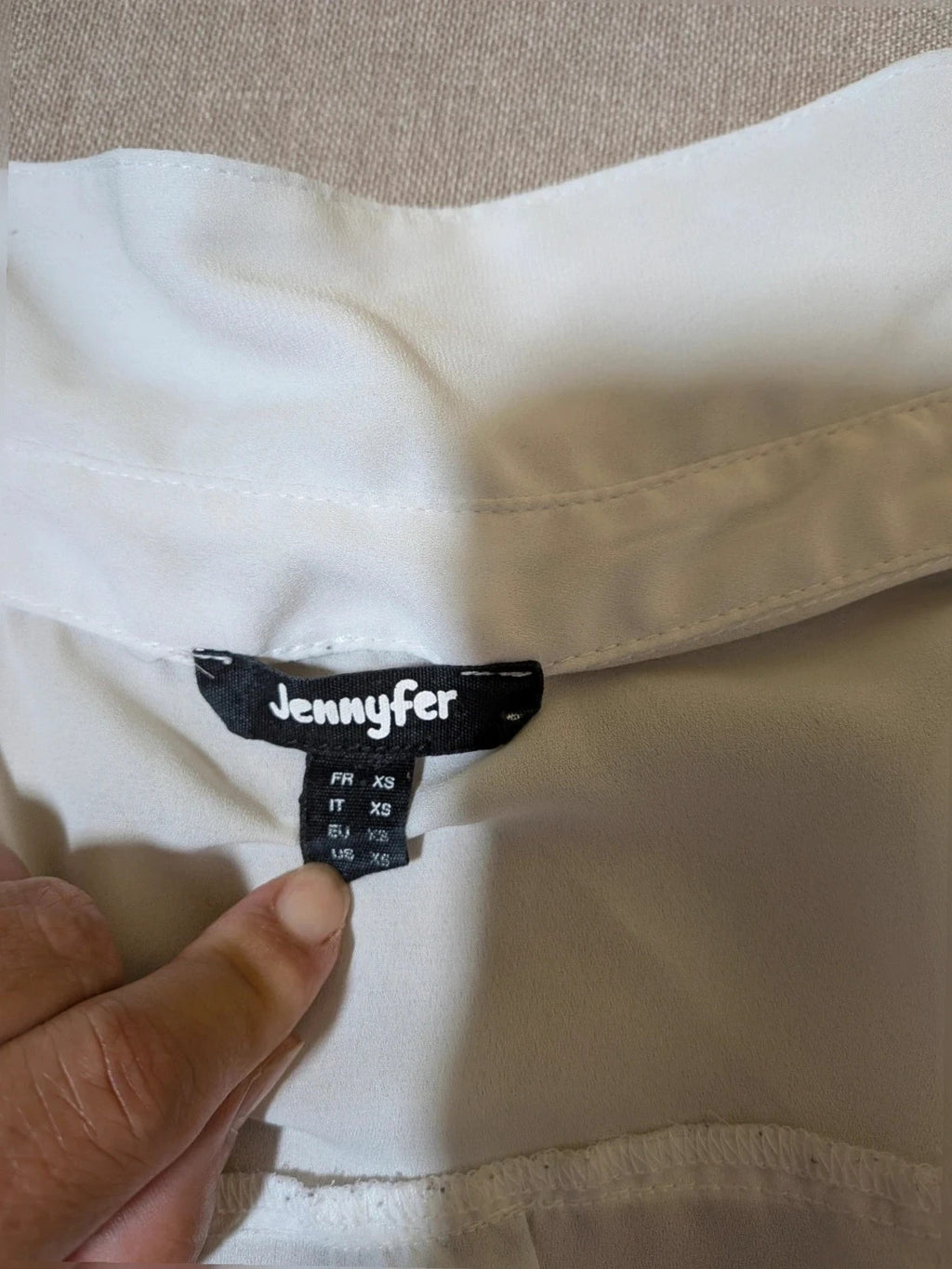 Jennifer beige skirt suit with floral pattern, white button-up shirt, lightweight polyester fabric.