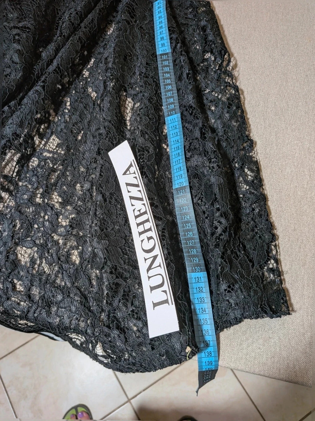 Chic black linen maxi dress with floral lace, white side stripe, and sleeveless design.