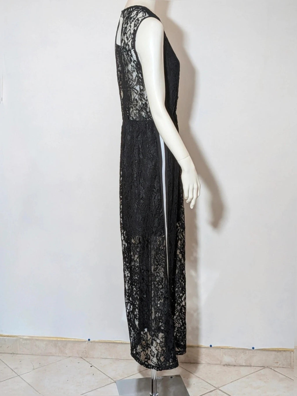 Chic black linen maxi dress with floral lace, white side stripe, and sleeveless design.