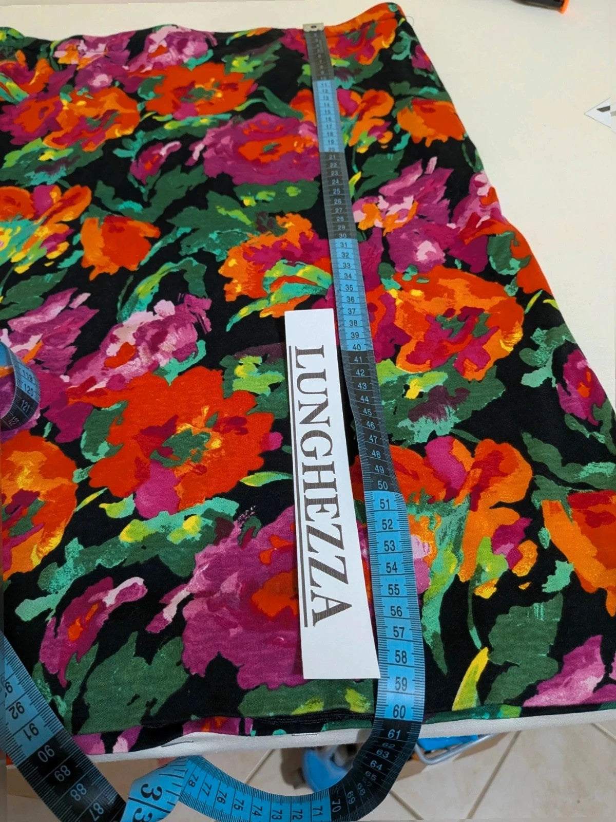 Leda Grotte black floral skirt suit with gold buttons and short balloon sleeves.