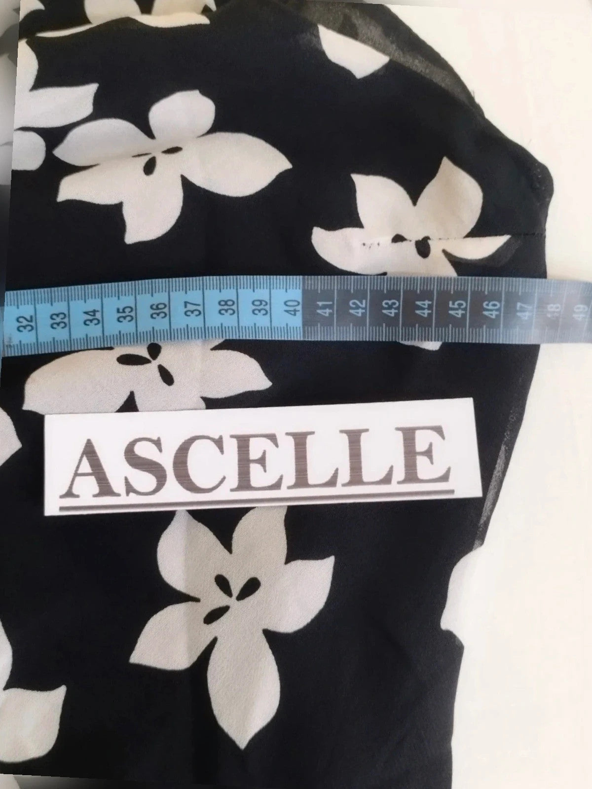 Cannella black and white floral linen maxi dress, one-shoulder design with ruffle detail.