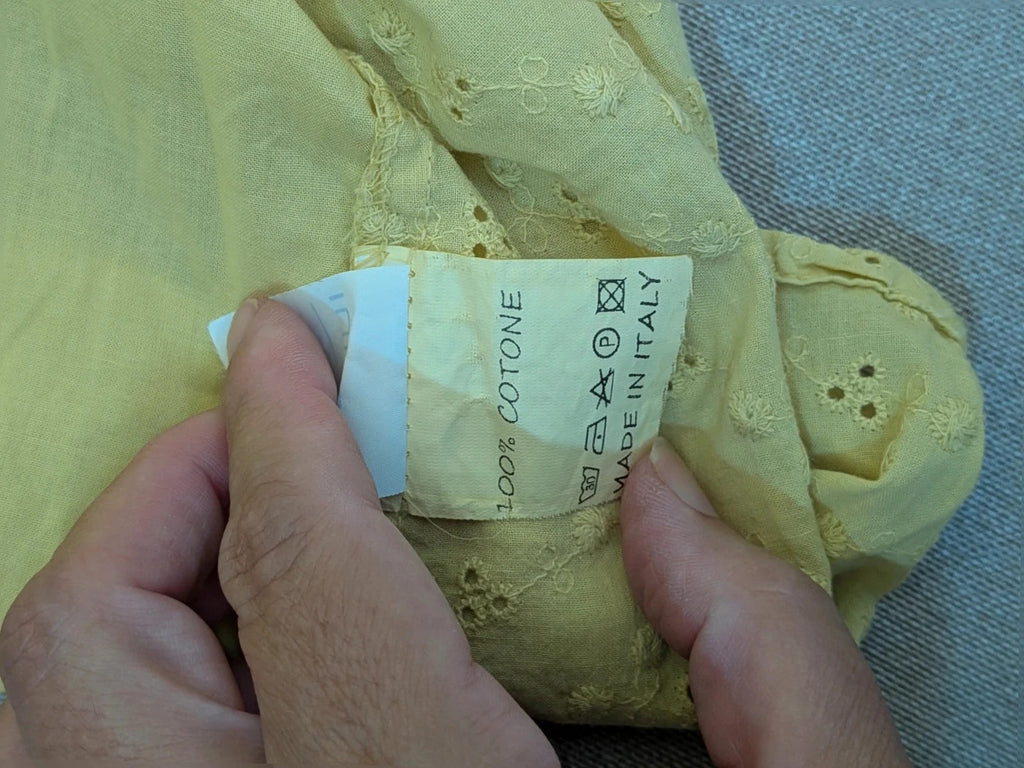 Guerini yellow short-sleeve top with lace Sangallo pattern and front button closure.