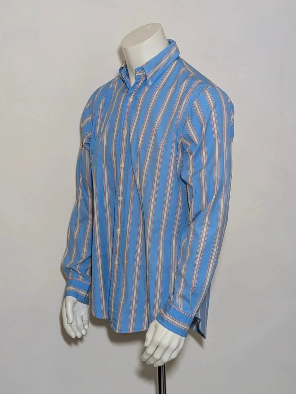 Polo Ralph Lauren multicolor striped shirt with pink pony logo on sky blue background.