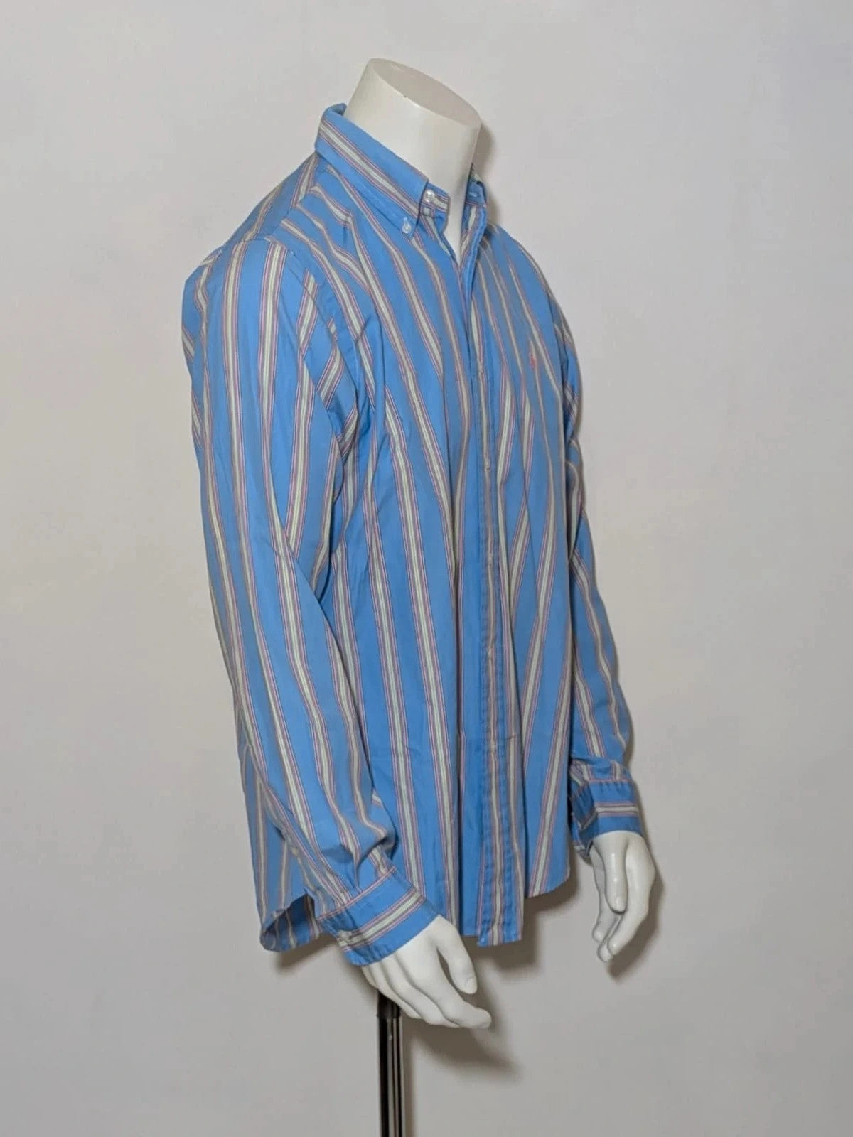 Polo Ralph Lauren multicolor striped shirt with pink pony logo on sky blue background.