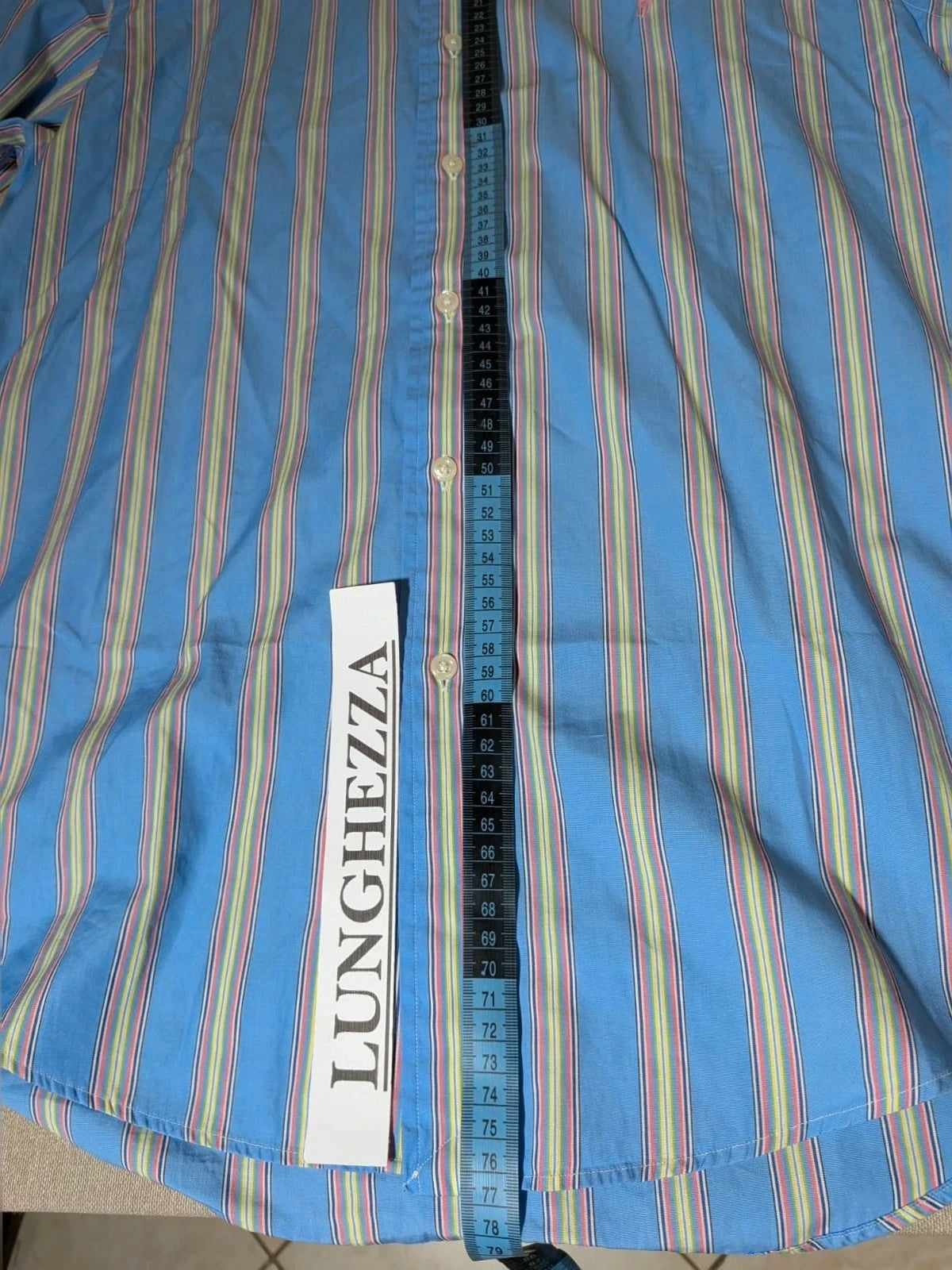 Polo Ralph Lauren multicolor striped shirt with pink pony logo on sky blue background.
