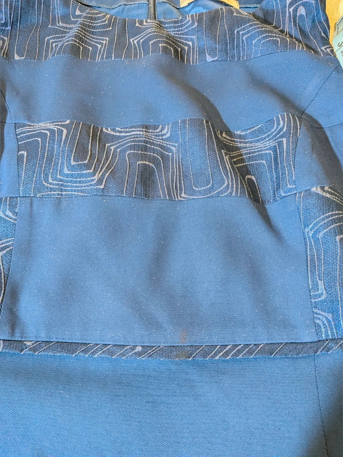 Momenti blue skirt suit with geometric jacquard pattern and fitted jacket.