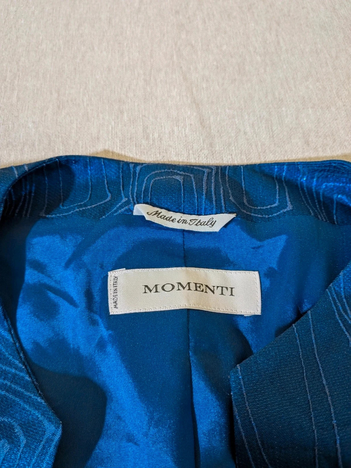 Momenti blue skirt suit with geometric jacquard pattern and fitted jacket.