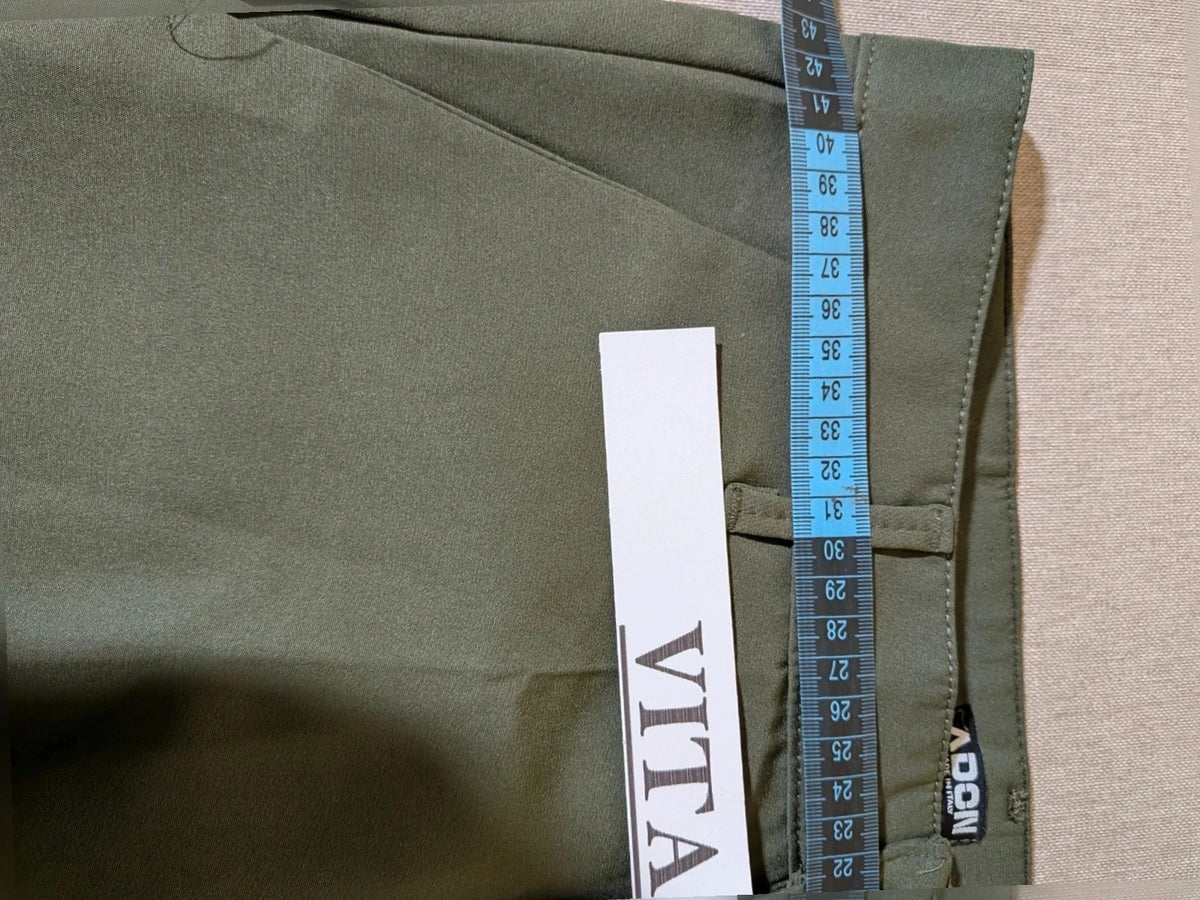 Adon green suit with gold jewel button and embossed heraldic emblem.