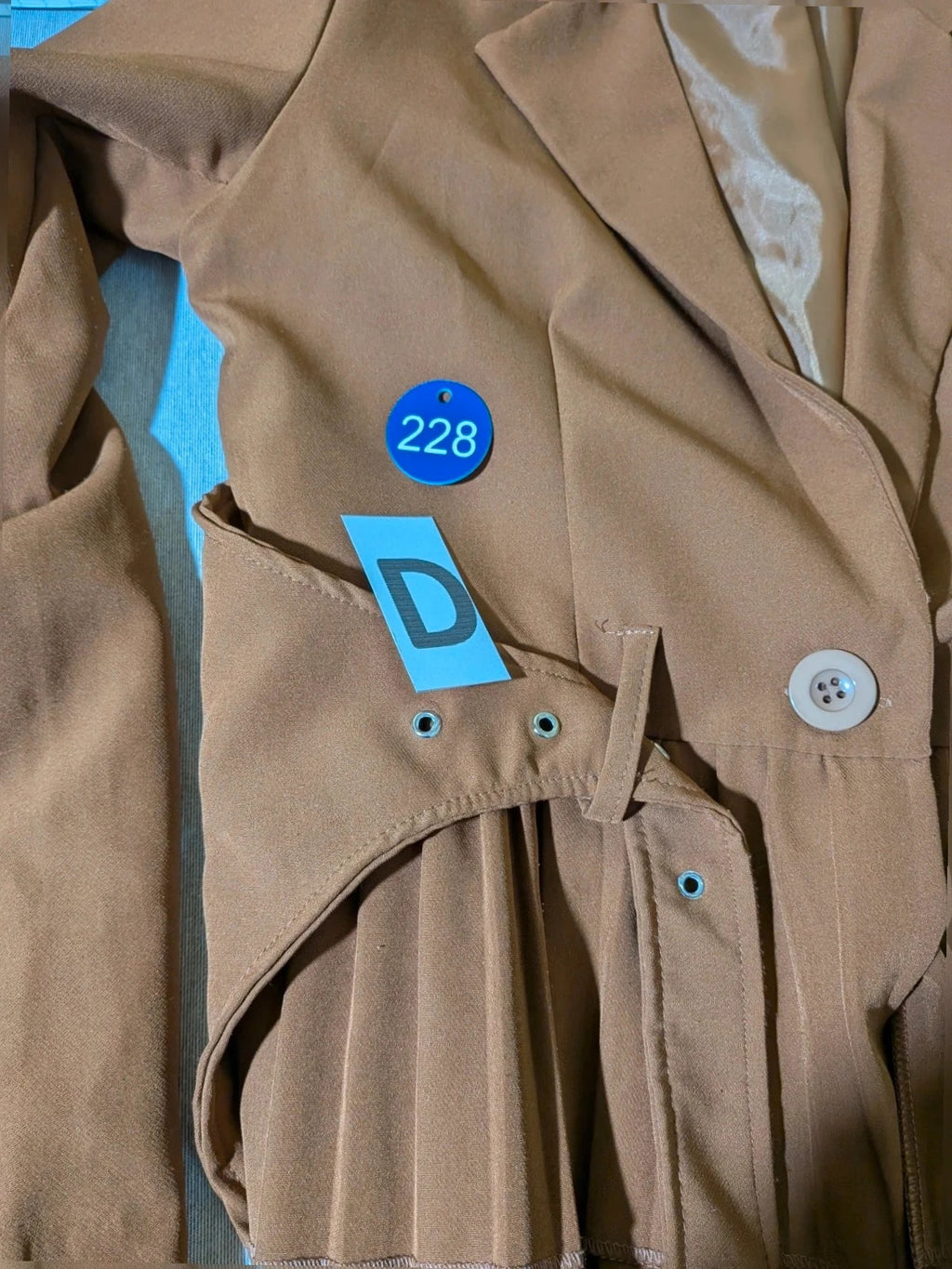 New Collection brown blazer with unique design and feminine belt detail.