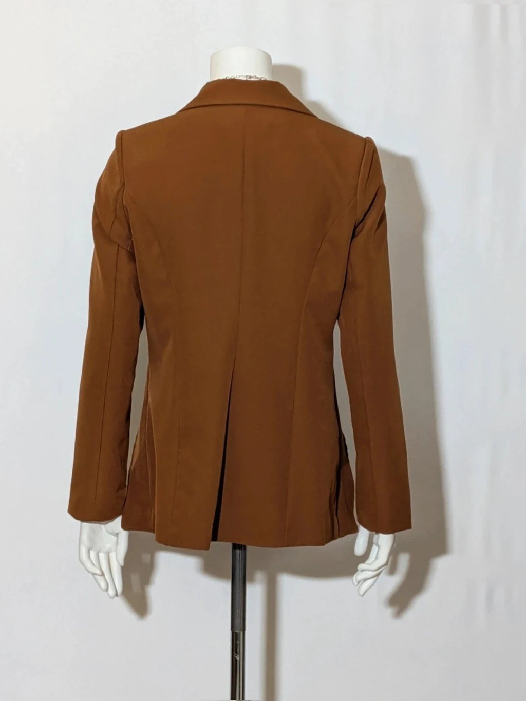 New Collection brown blazer with unique design and feminine belt detail.
