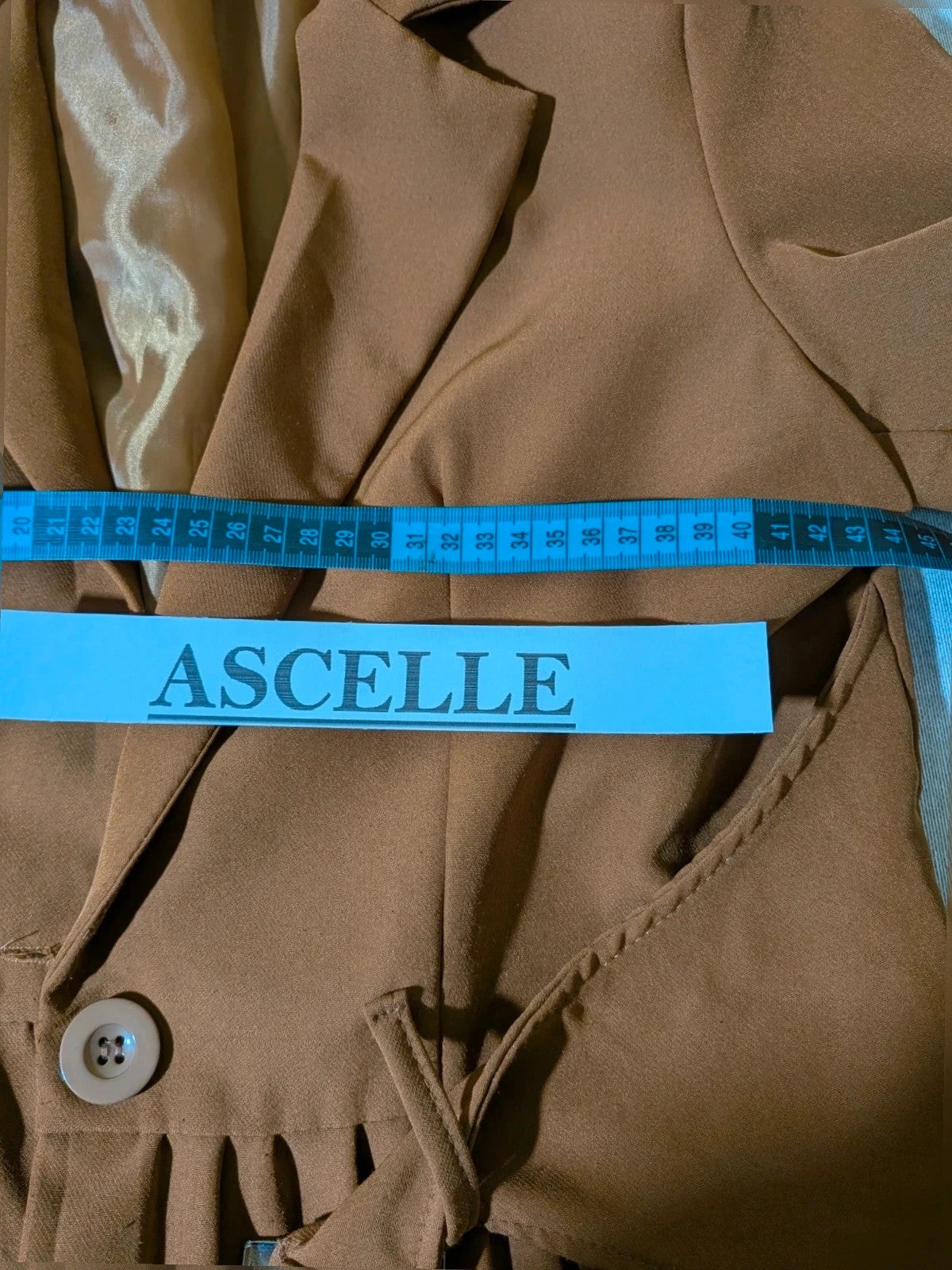 New Collection brown blazer with unique design and feminine belt detail.