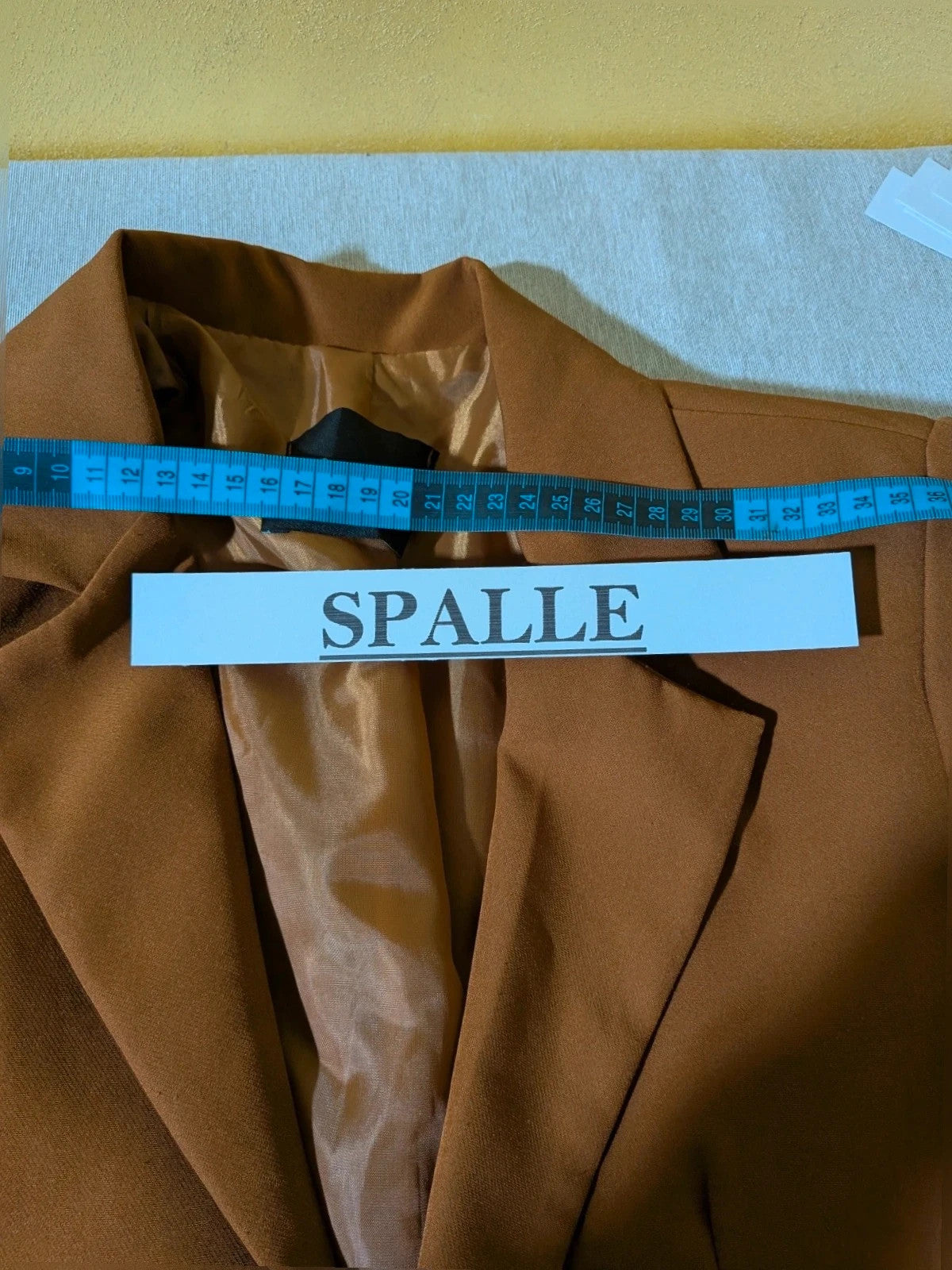 New Collection brown blazer with unique design and feminine belt detail.