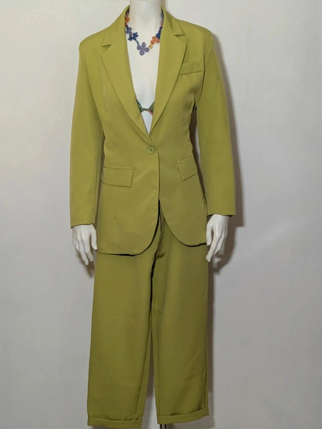 New Collection green suit set with fitted blazer, wide-leg trousers, and classic lapel details.
