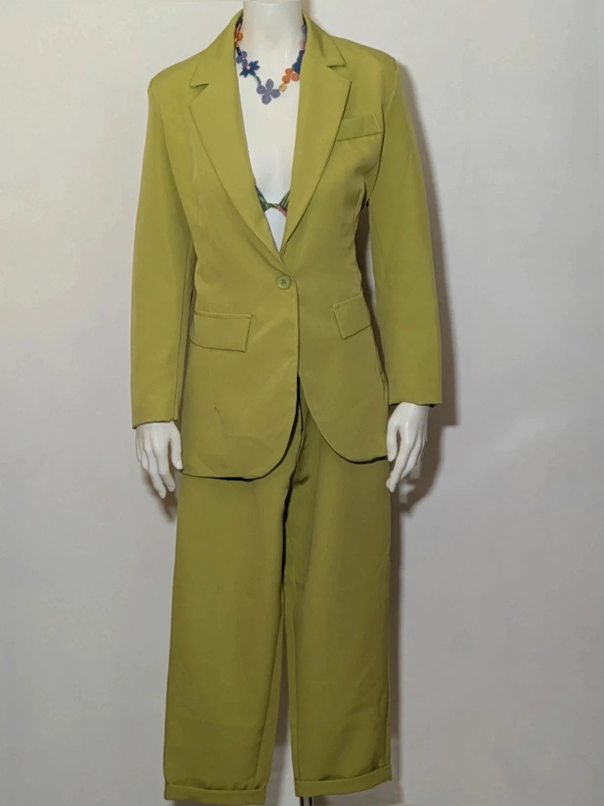 New Collection green suit set with fitted blazer, wide-leg trousers, and classic lapel details.