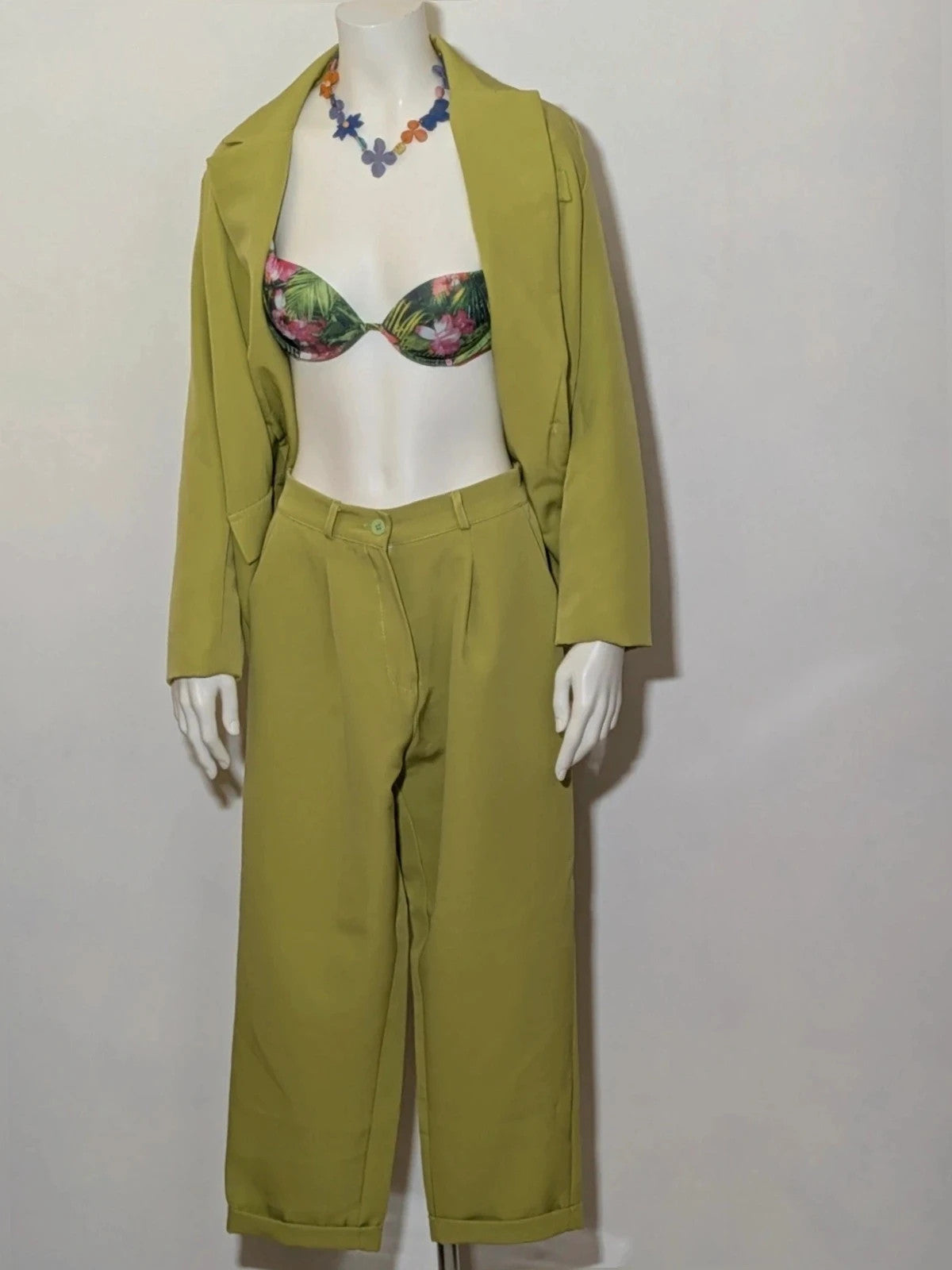 New Collection green suit set with fitted blazer, wide-leg trousers, and classic lapel details.