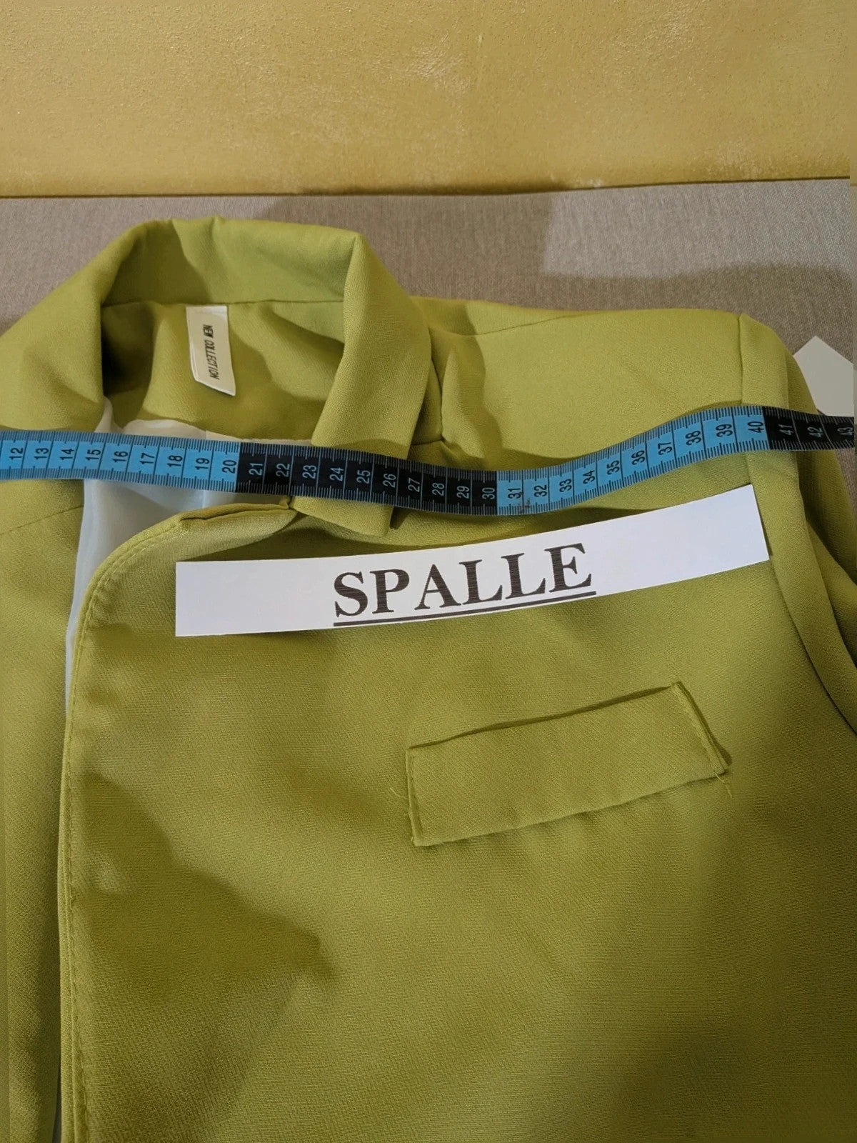 New Collection green suit set with fitted blazer, wide-leg trousers, and classic lapel details.