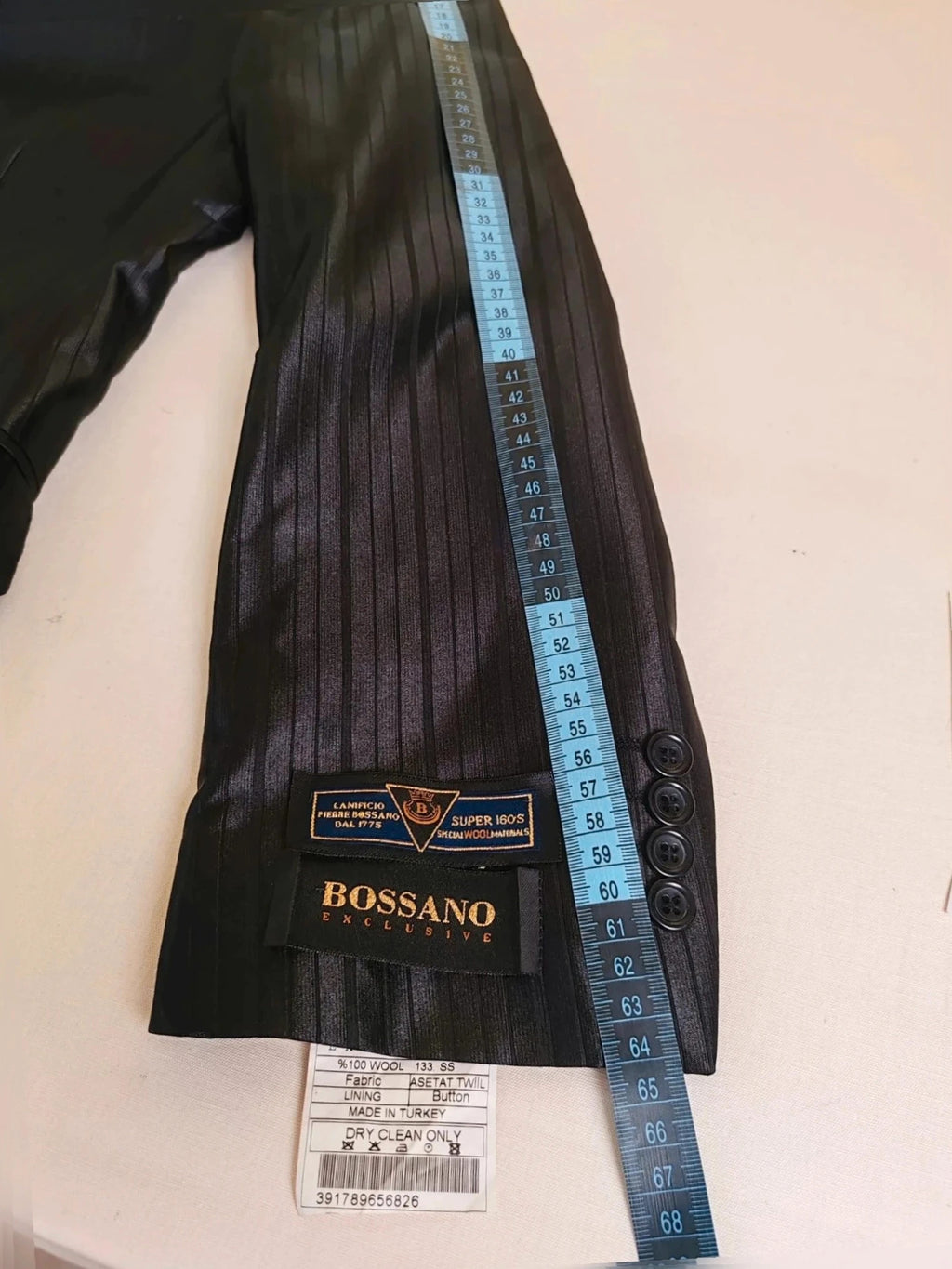 Bossano black suit jacket and trousers, pinstripe pattern, luxurious satin finish, new with tags.