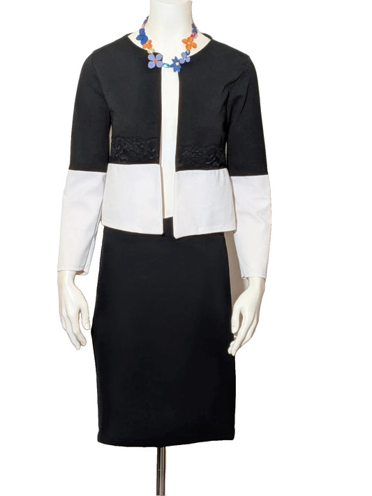 Silhouette black and white skirt suit with lace detail and bolero-style jacket.