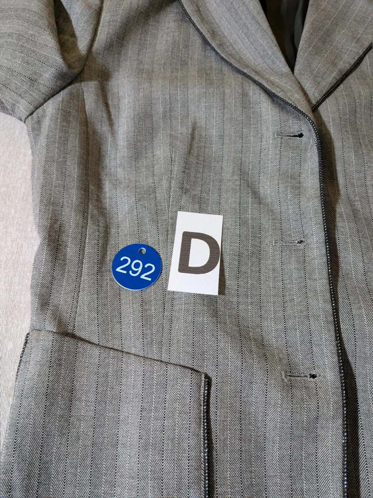 Taifun grey pinstriped blazer with satin black trim and logo lining.