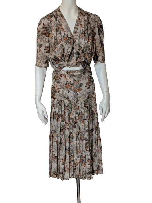 Bellissima beige floral print skirt suit with V-neck blouse and pleated midi skirt.