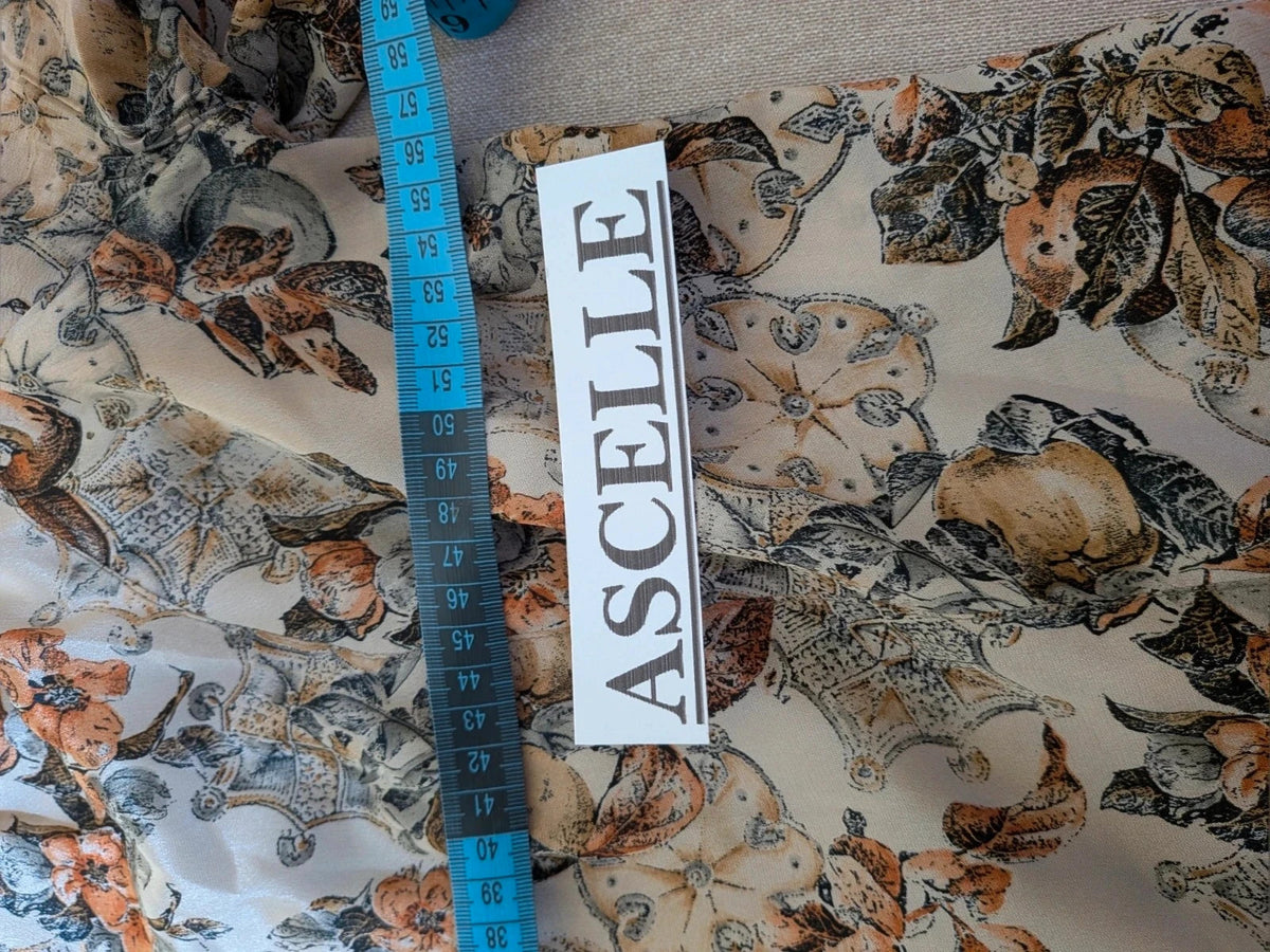 Bellissima beige floral print skirt suit with V-neck blouse and pleated midi skirt.