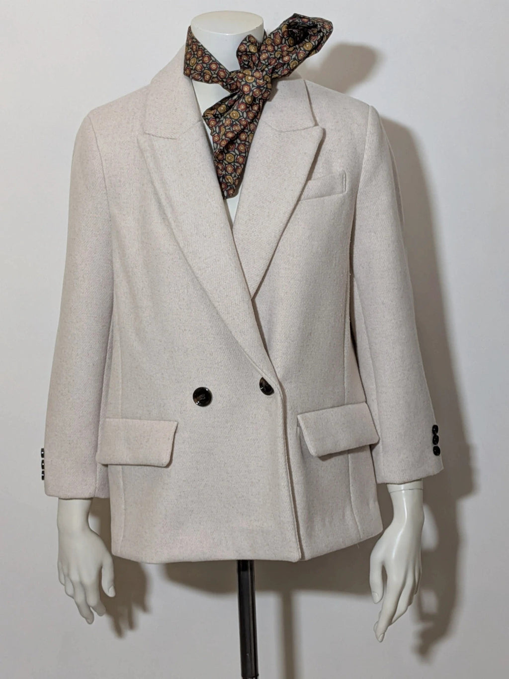 OVS beige double-breasted blazer with dark button closure and classic lapels.