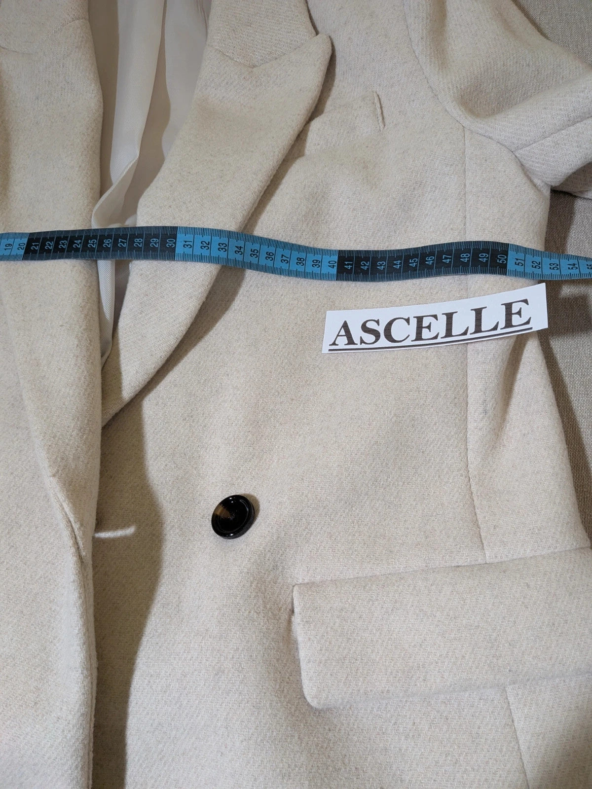 OVS beige double-breasted blazer with dark button closure and classic lapels.