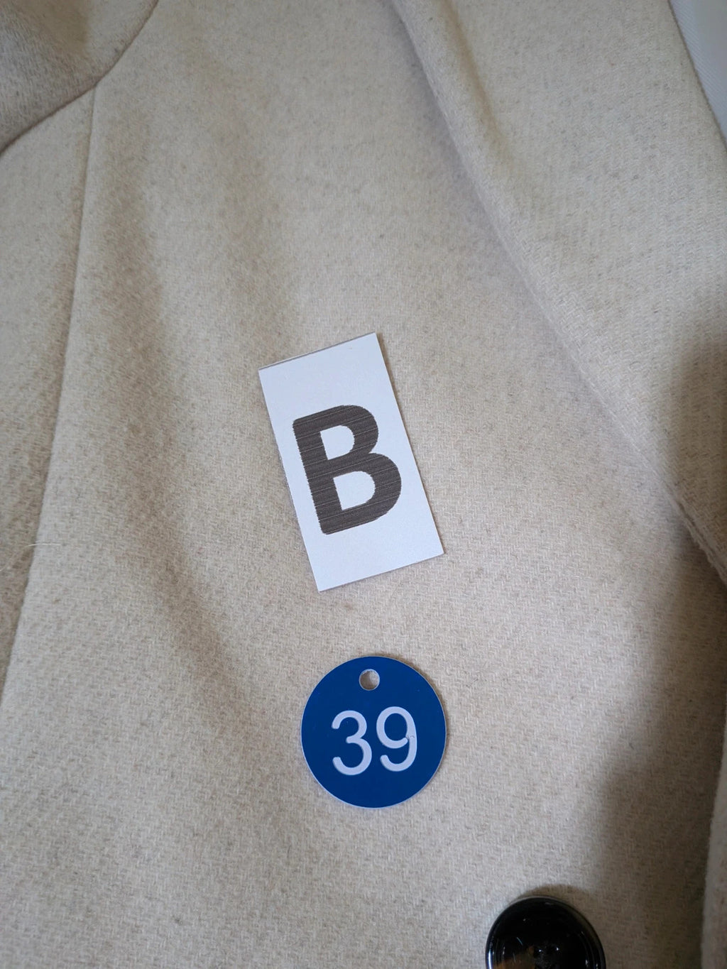 OVS beige double-breasted blazer with dark button closure and classic lapels.