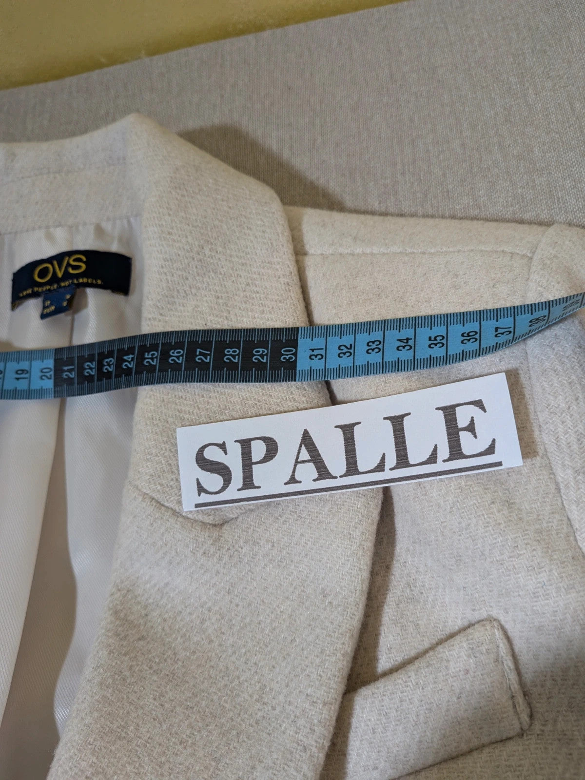 OVS beige double-breasted blazer with dark button closure and classic lapels.