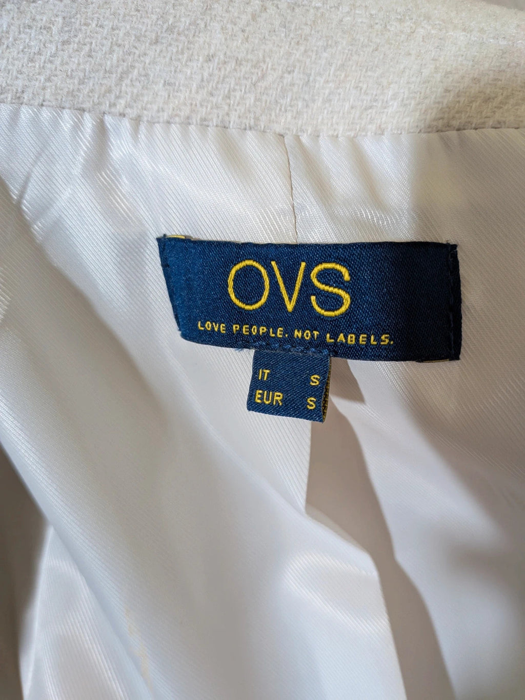 OVS beige double-breasted blazer with dark button closure and classic lapels.