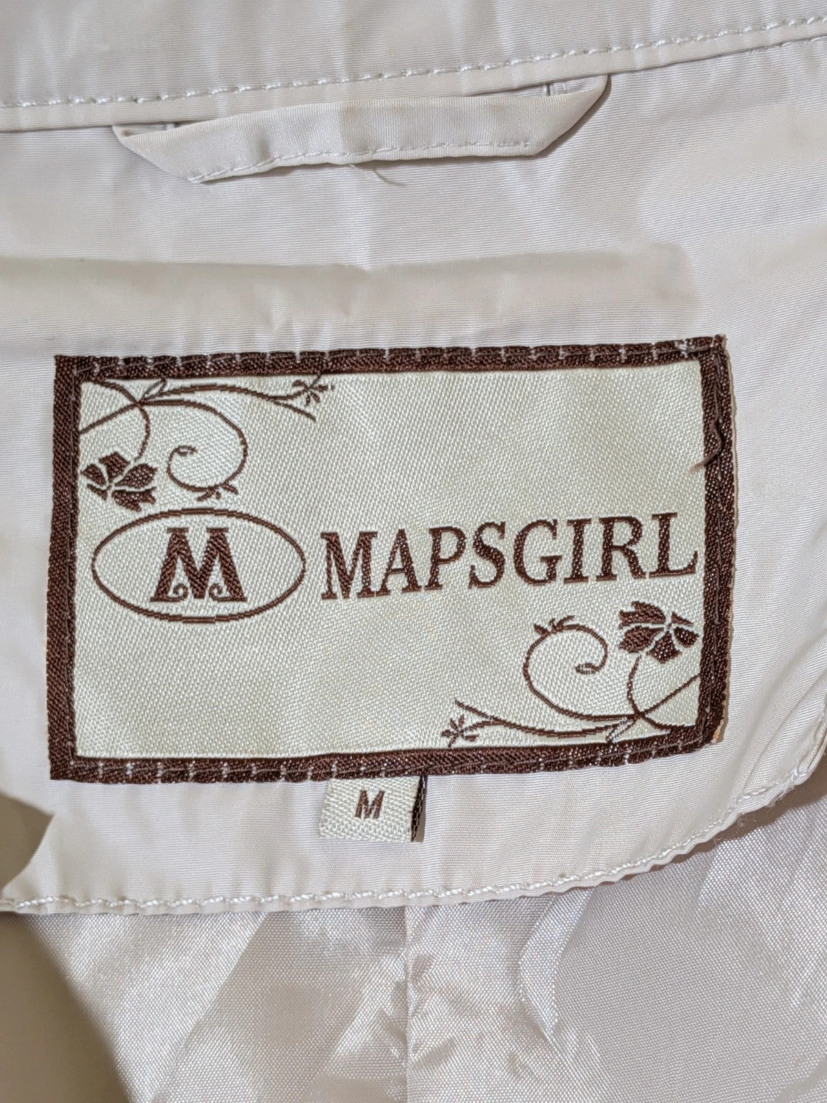 Maps Girl beige trench coat lightweight double-breasted buttons, structured shoulders, adjustable waist belt.