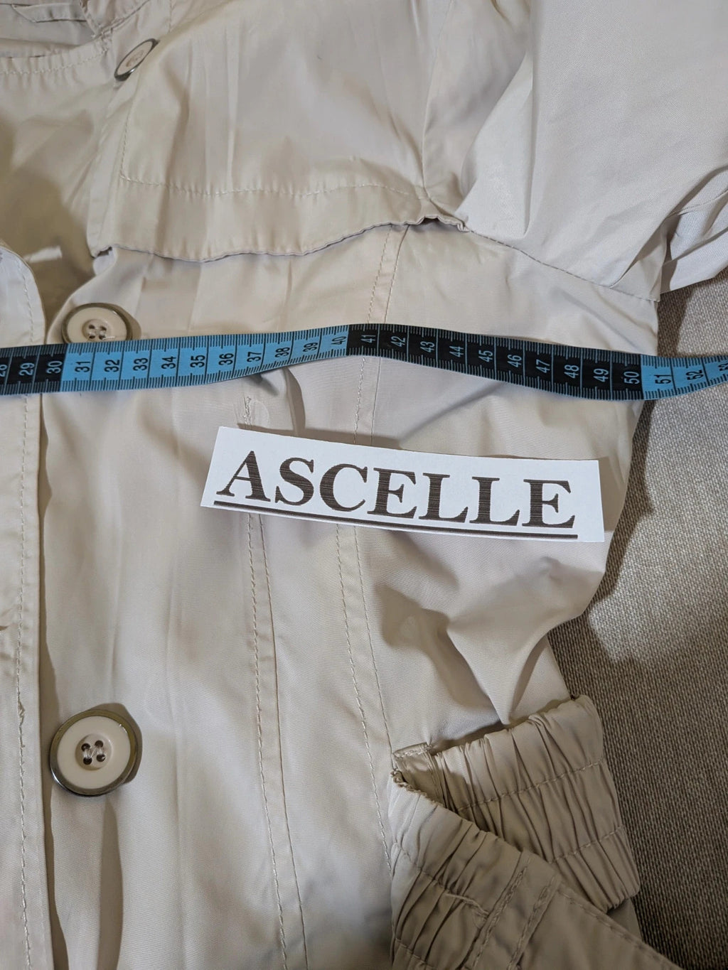 Maps Girl beige trench coat lightweight double-breasted buttons, structured shoulders, adjustable waist belt.