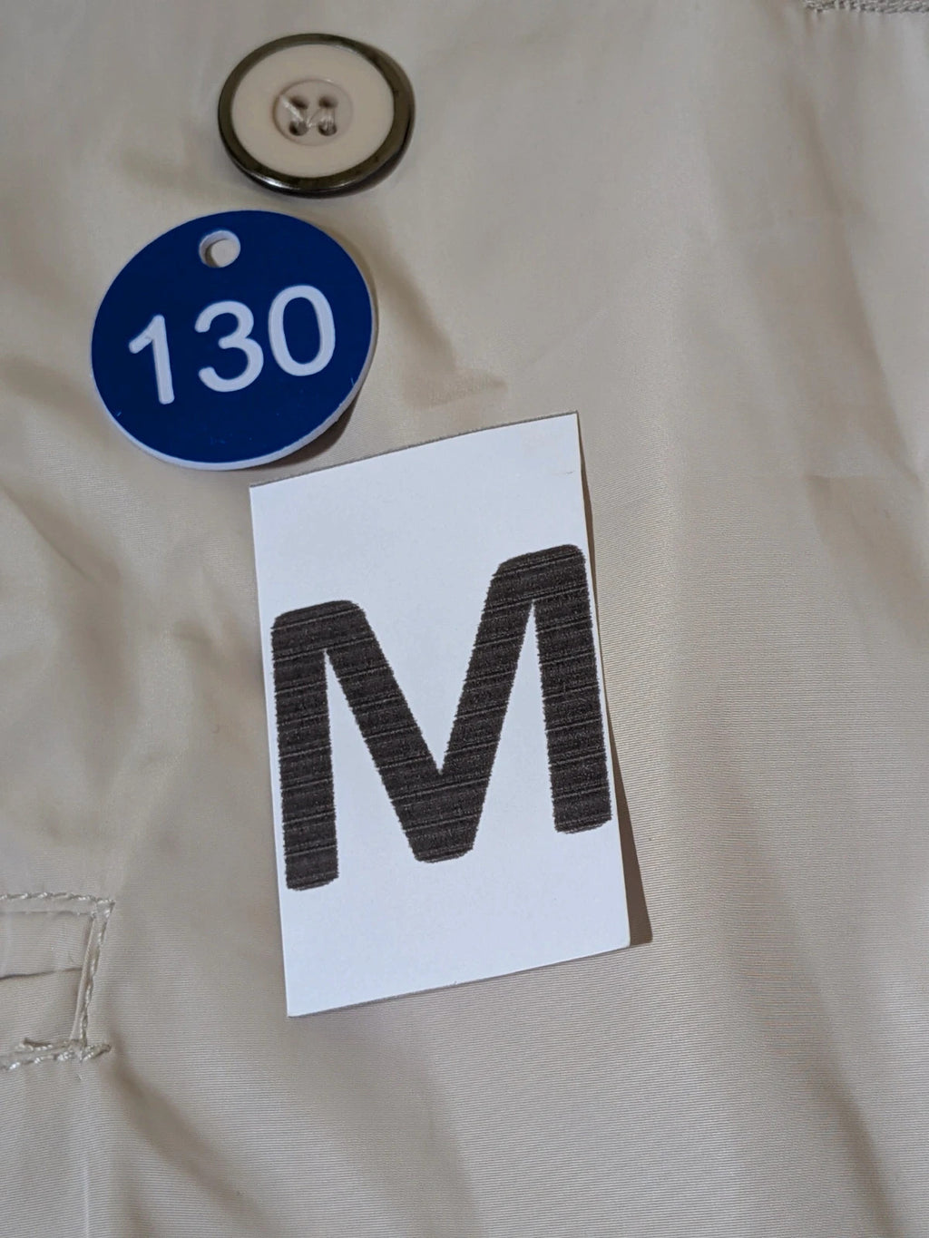 Maps Girl beige trench coat lightweight double-breasted buttons, structured shoulders, adjustable waist belt.