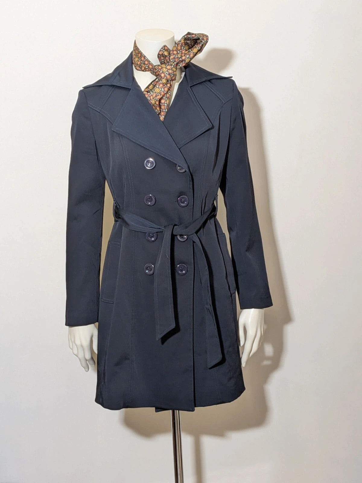 Pepe navy trench coat with double-breasted buttons, belted waist, and structured shoulders.