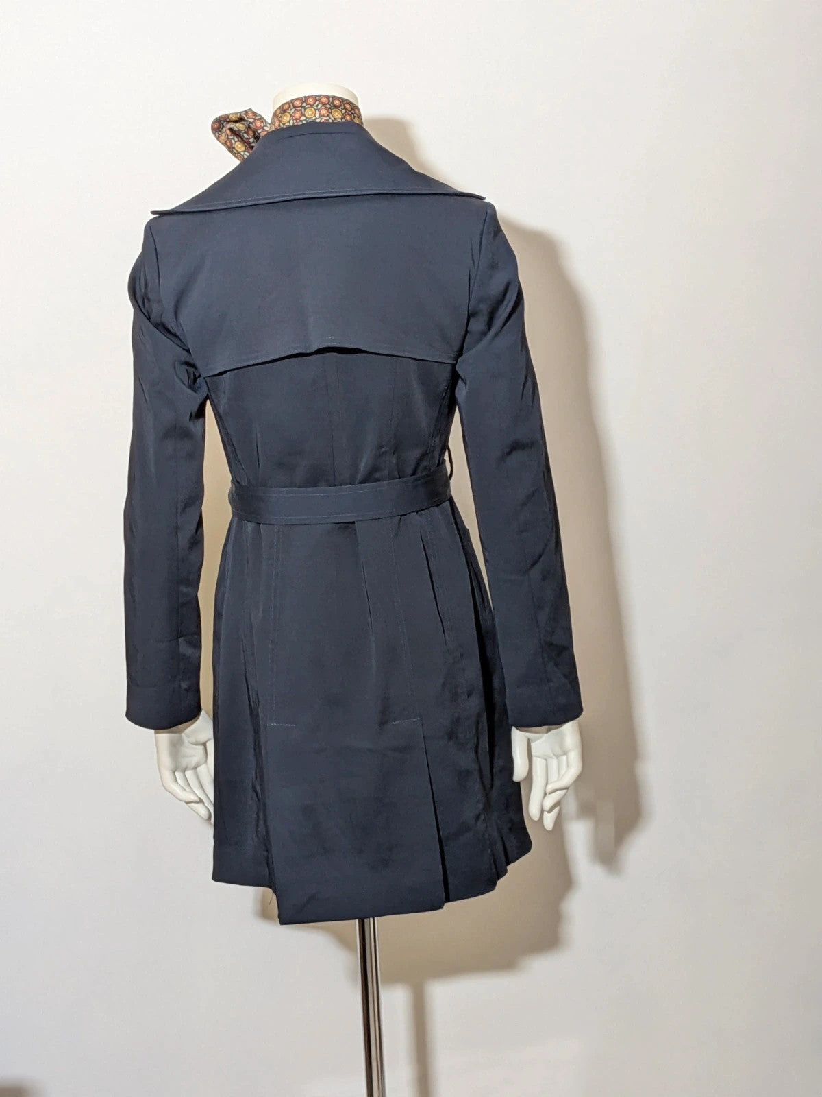 Pepe navy trench coat with double-breasted buttons, belted waist, and structured shoulders.