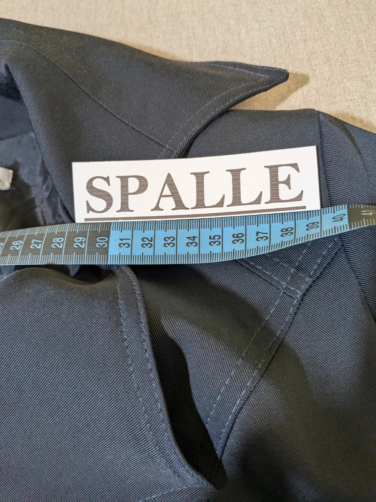 Pepe navy trench coat with double-breasted buttons, belted waist, and structured shoulders.