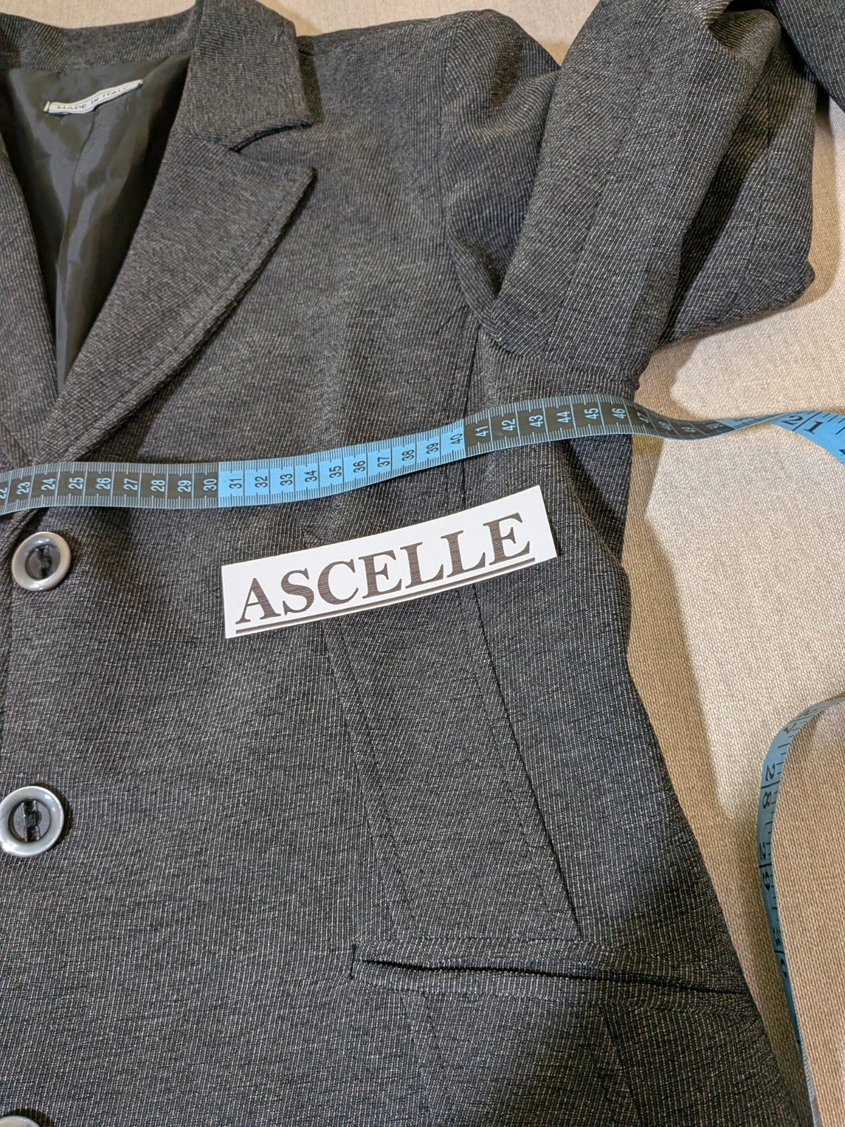 Made in Italy grey suit with three-button jacket and straight-leg trousers, soft fabric.