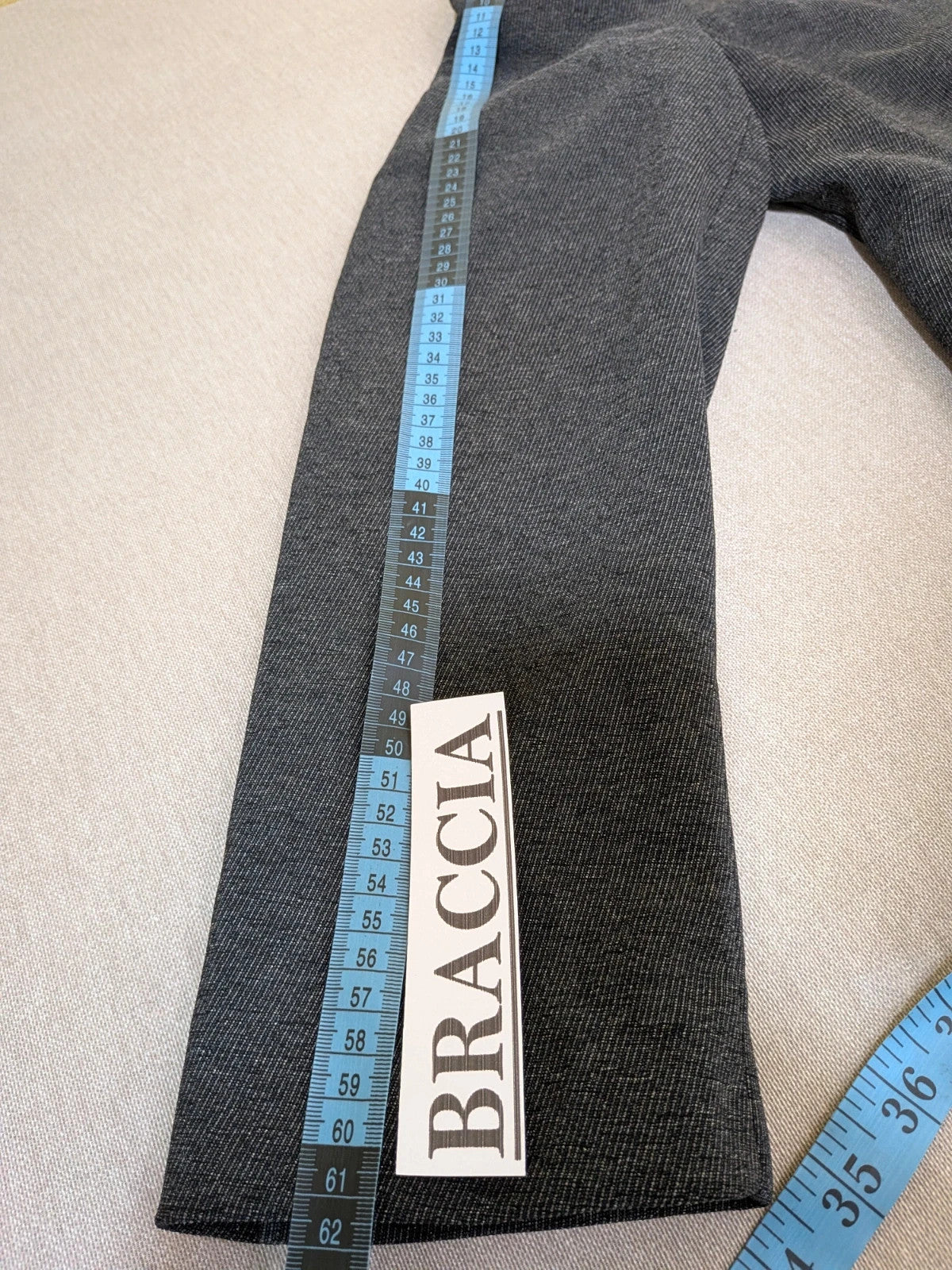 Made in Italy grey suit with three-button jacket and straight-leg trousers, soft fabric.