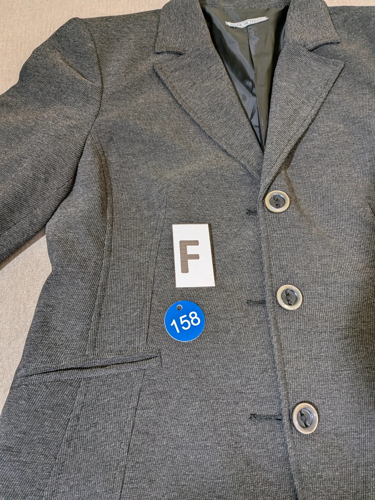 Made in Italy grey suit with three-button jacket and straight-leg trousers, soft fabric.