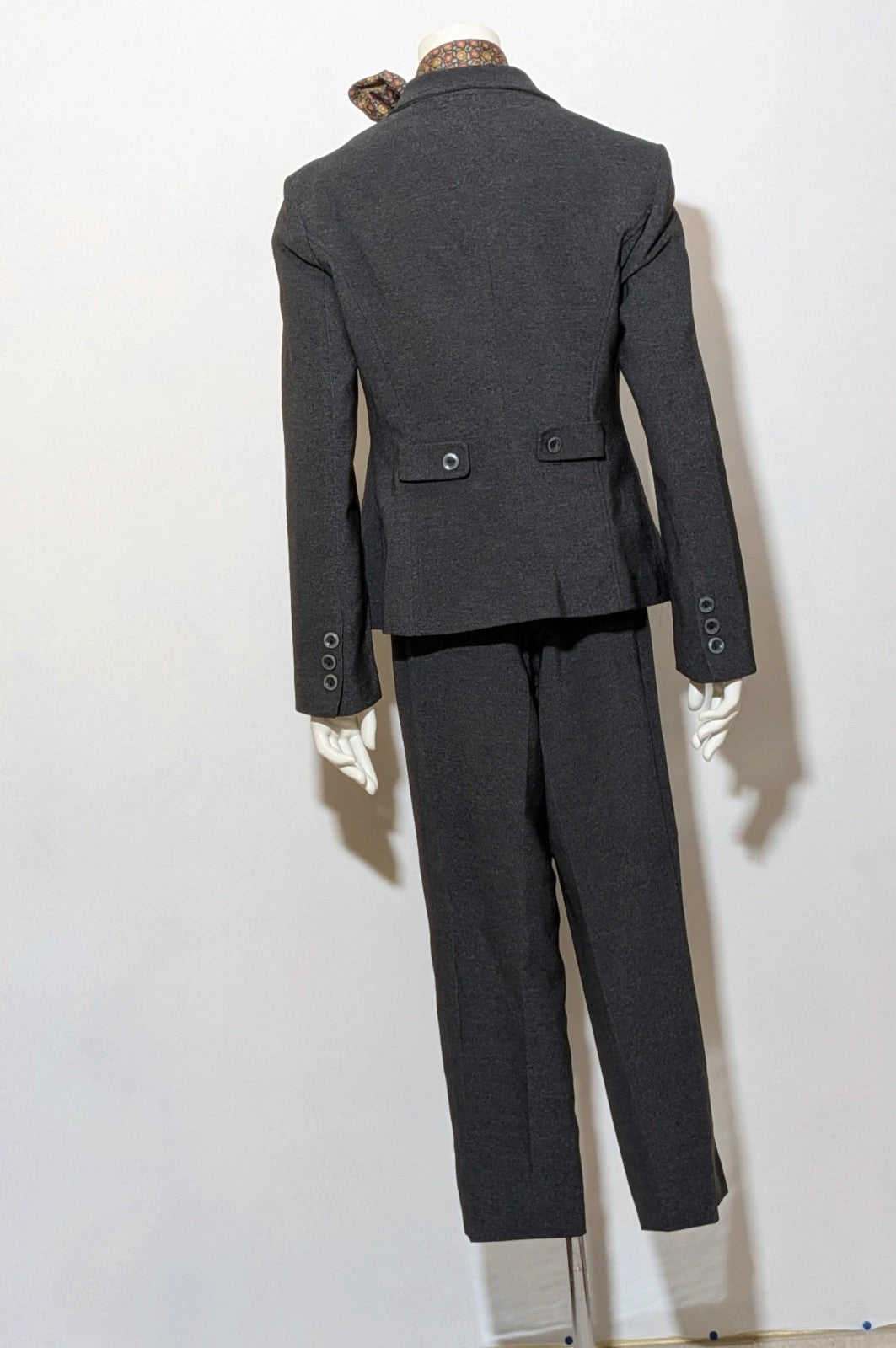 Made in Italy grey suit with three-button jacket and straight-leg trousers, soft fabric.