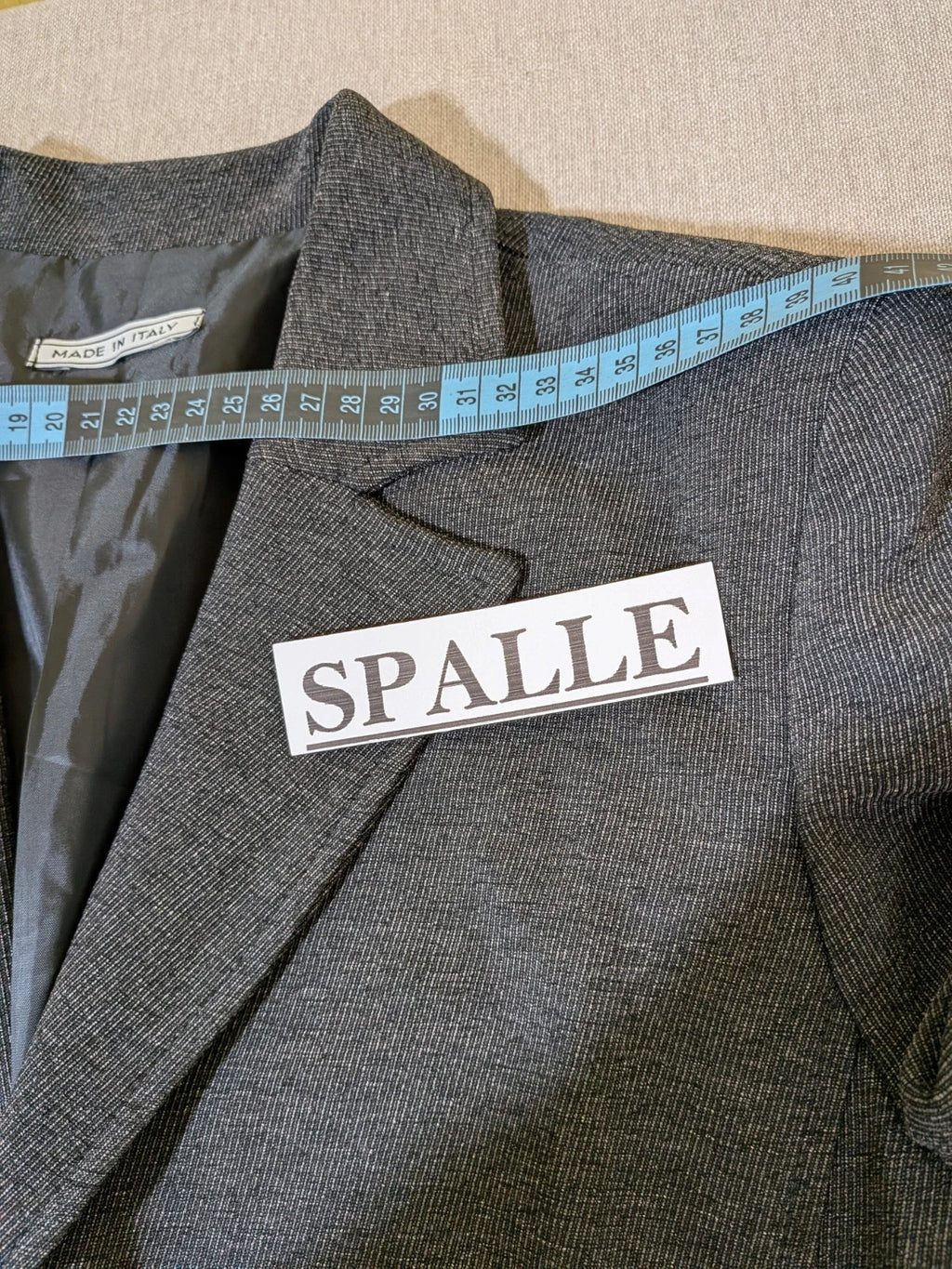 Made in Italy grey suit with three-button jacket and straight-leg trousers, soft fabric.
