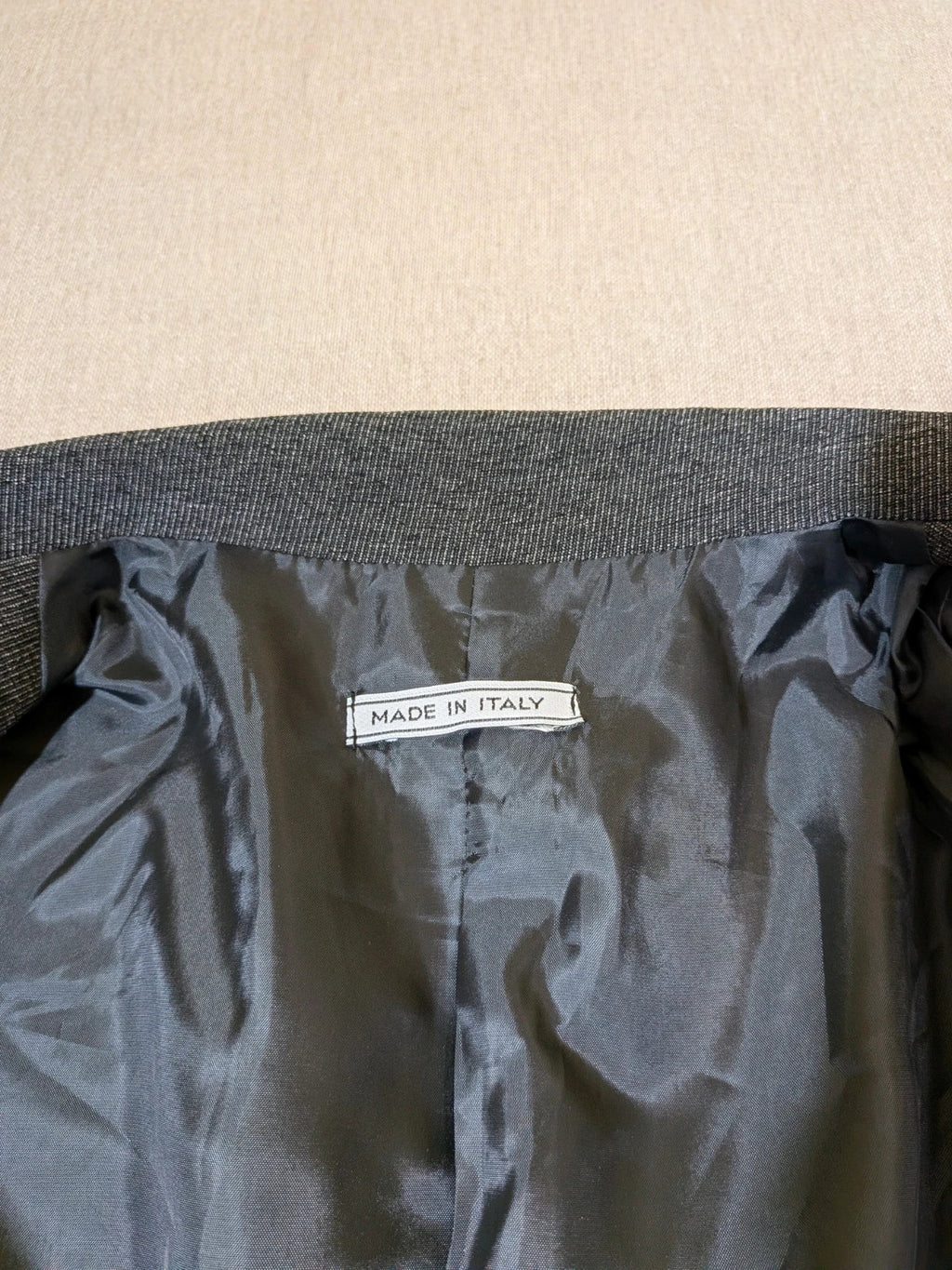 Made in Italy grey suit with three-button jacket and straight-leg trousers, soft fabric.